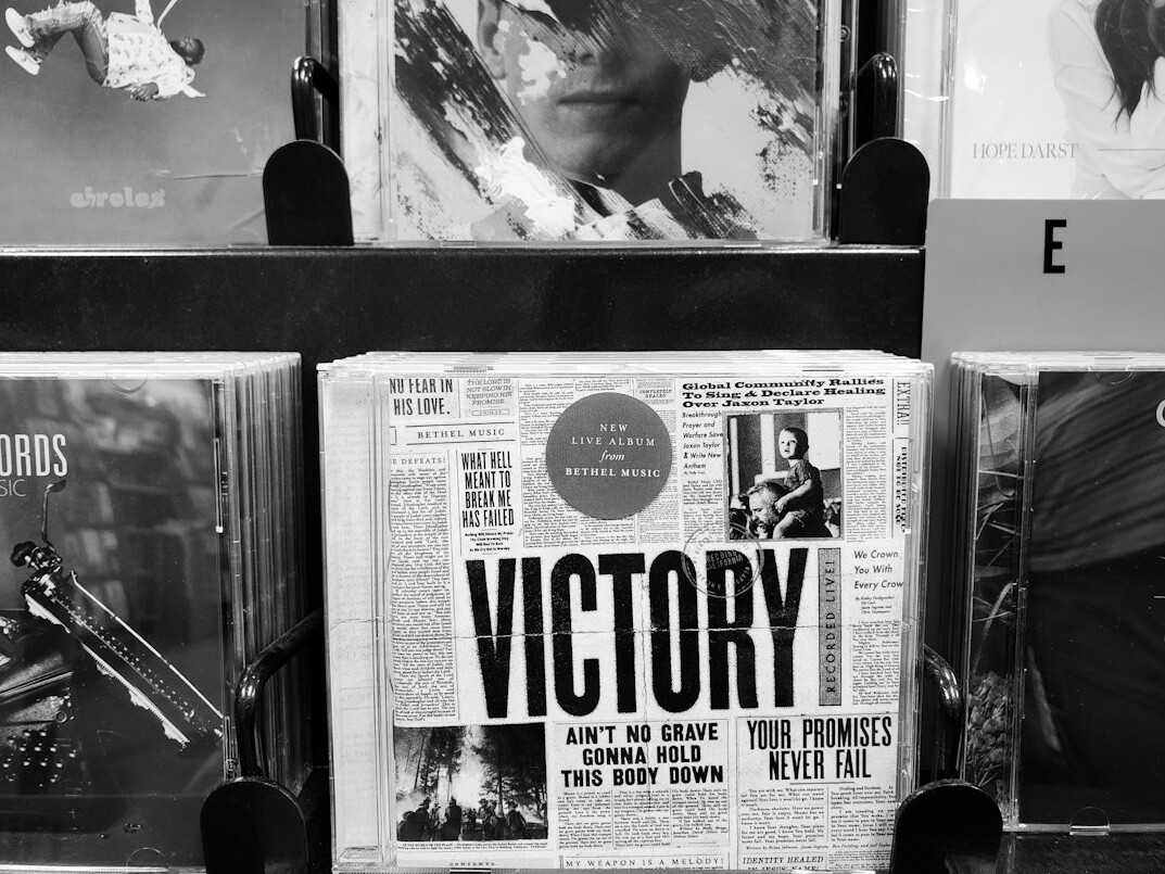 Newspapers and a notebook on a dark newsroom desk